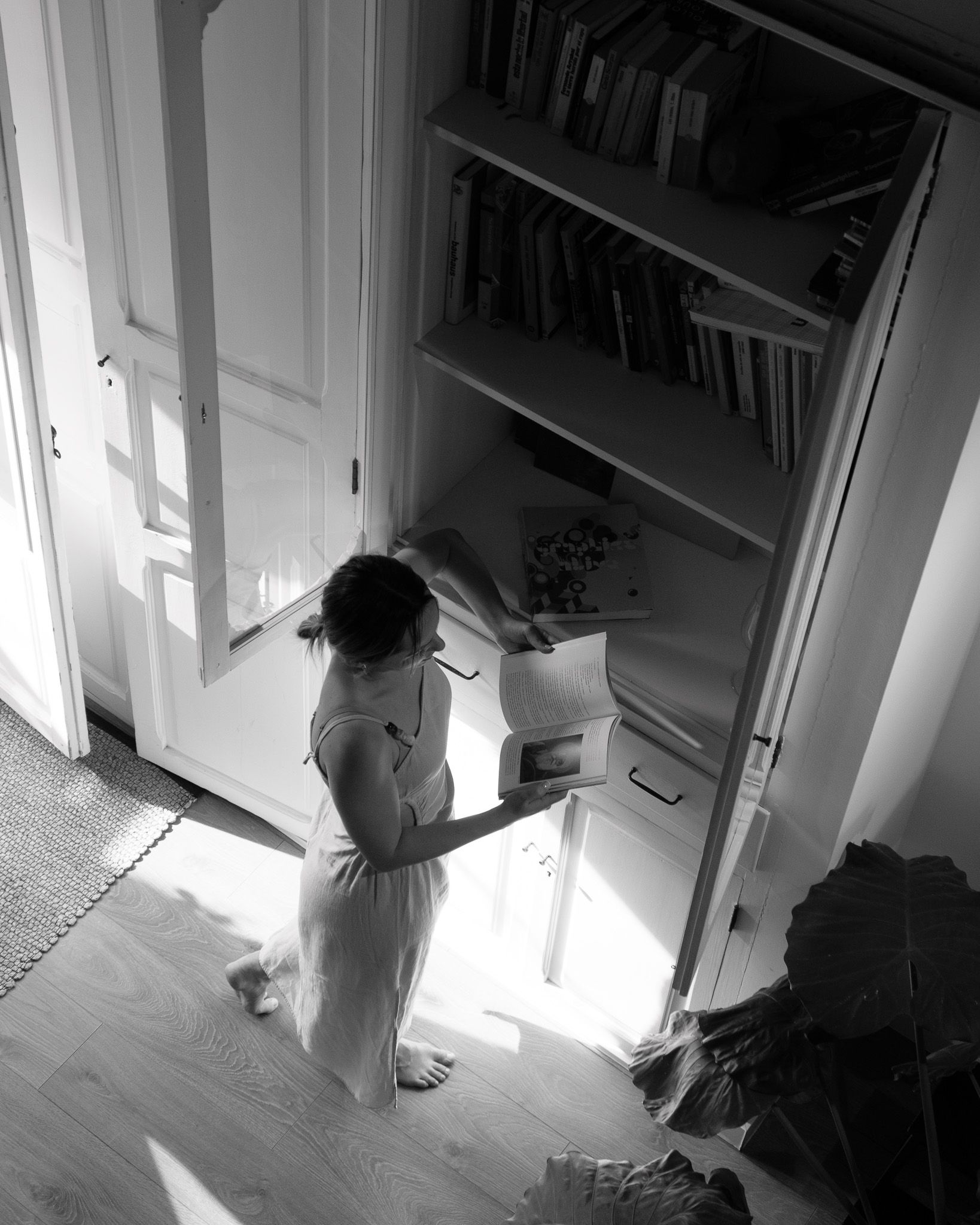 Barefoot woman reading inside a fishermen house in El Cabanyal, Valencia