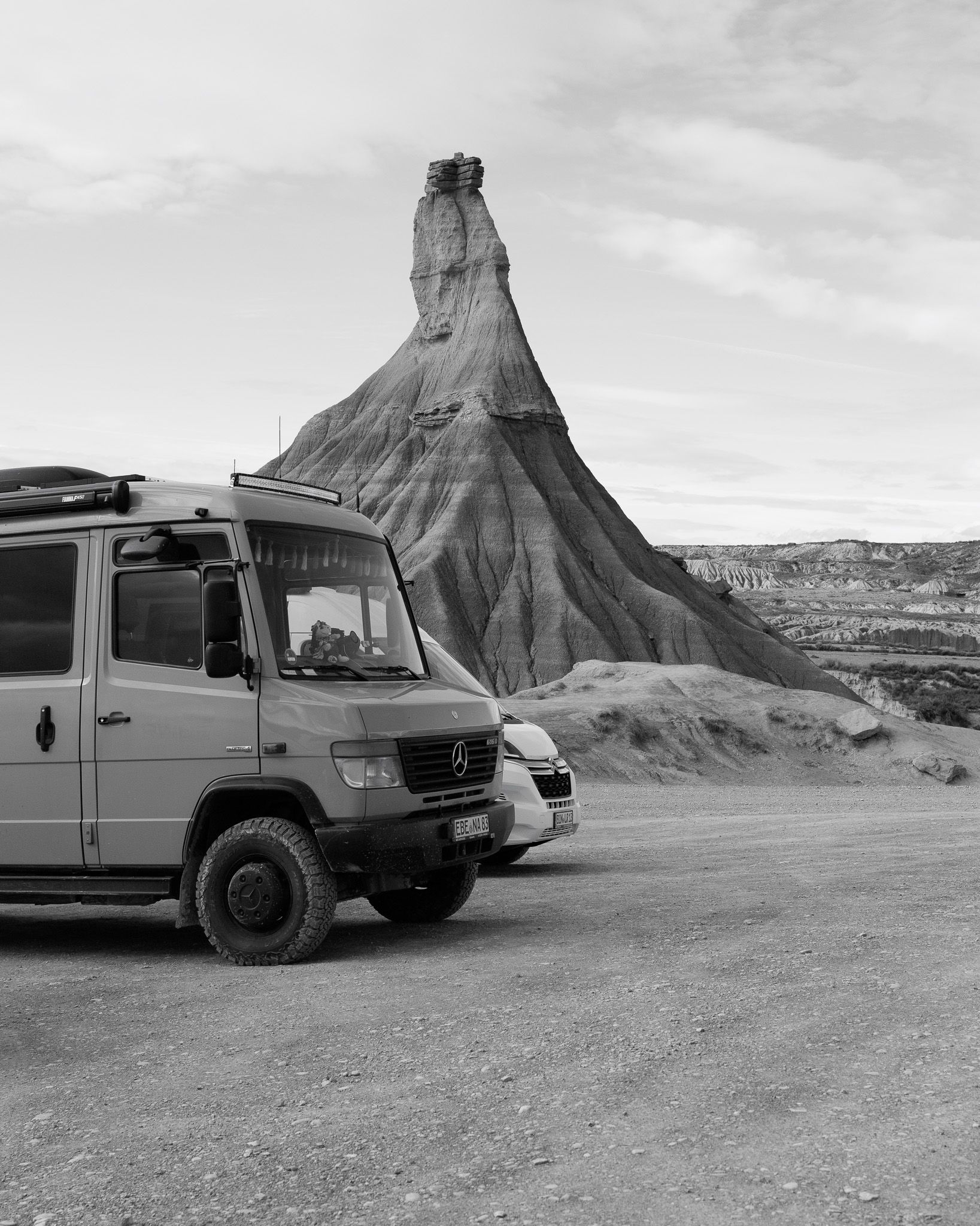 Castildetierra rock formation in the Bardenas Reales with travellers' vans